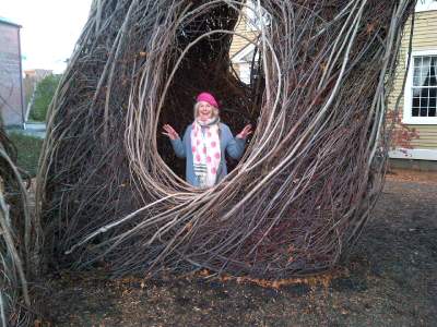 Carol in a tree sculpture